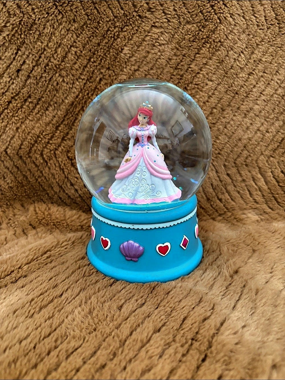 Disney The Little Mermaid Ariel snow globe on a blue base.